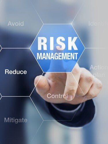professional pointing at graphic interface with text reading 'risk management'